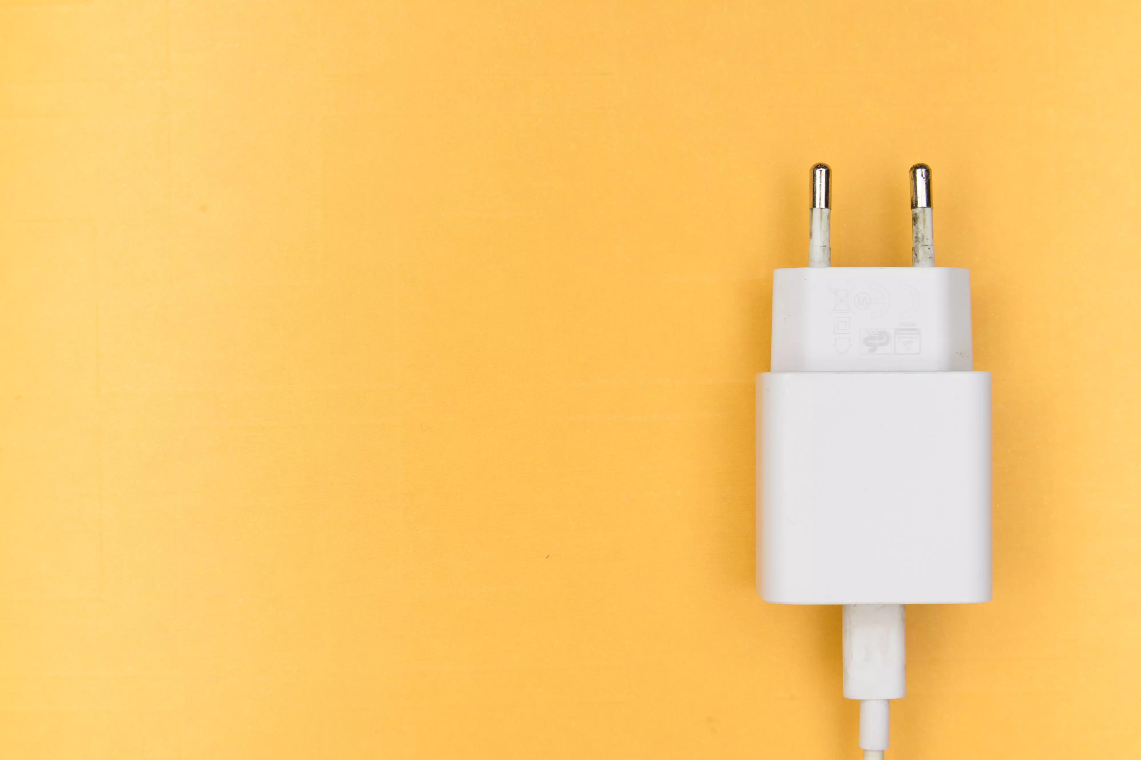 Phone charger on orange background